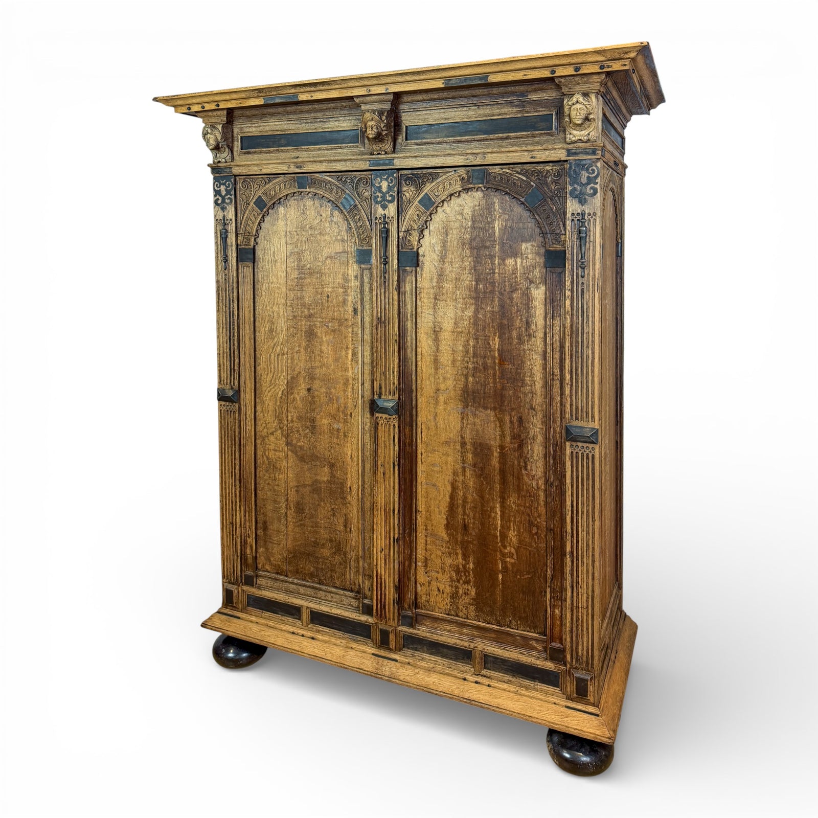 Oak Armoire with Carved Mask Corbels and Ebonized Details