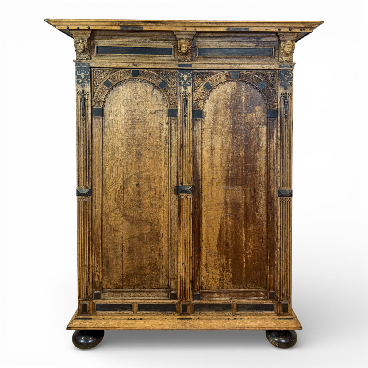 Oak Armoire with Carved Mask Corbels and Ebonized Details