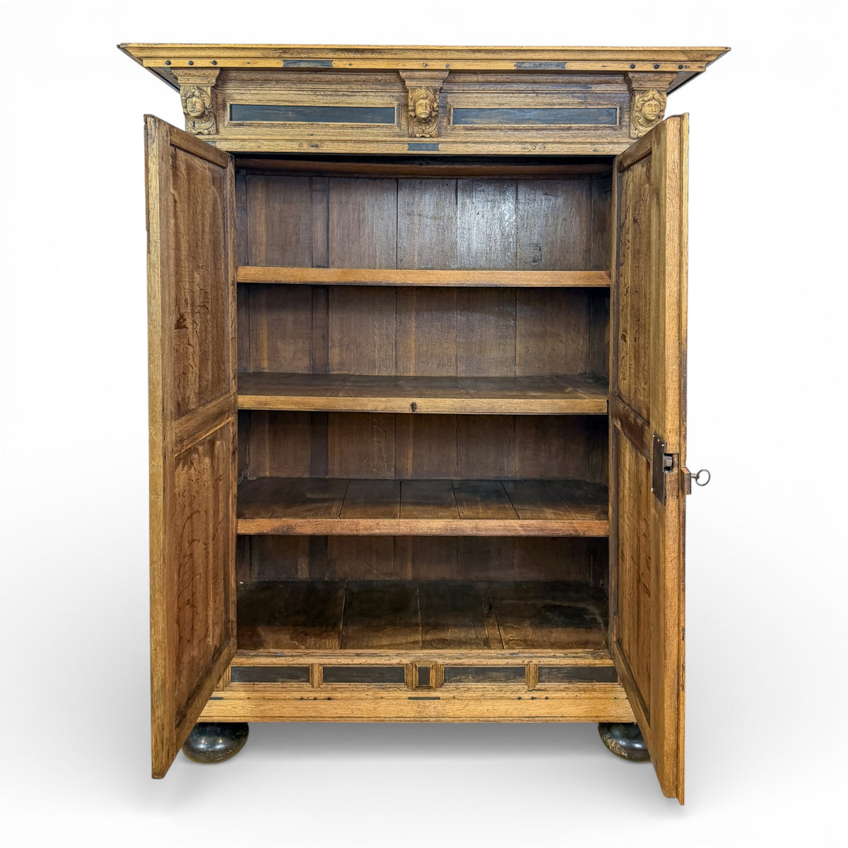 Oak Armoire with Carved Mask Corbels and Ebonized Details